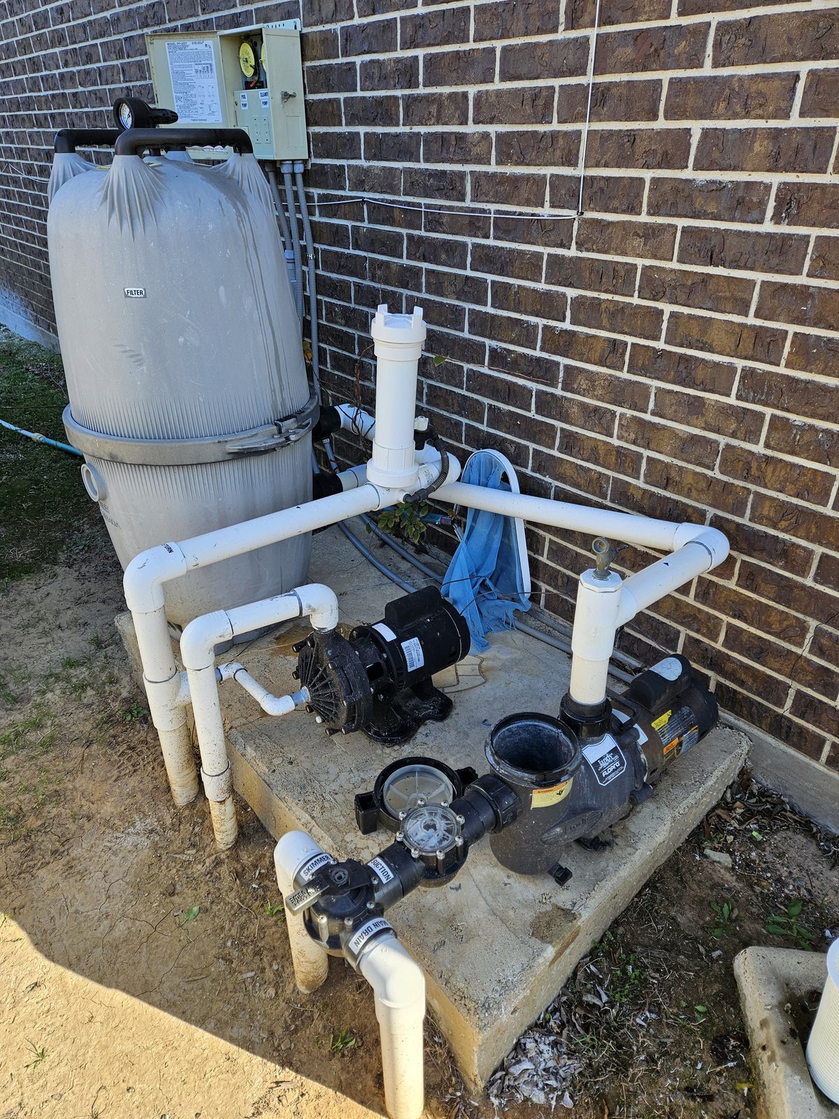 Pool pump and filter on a raised equipment platform