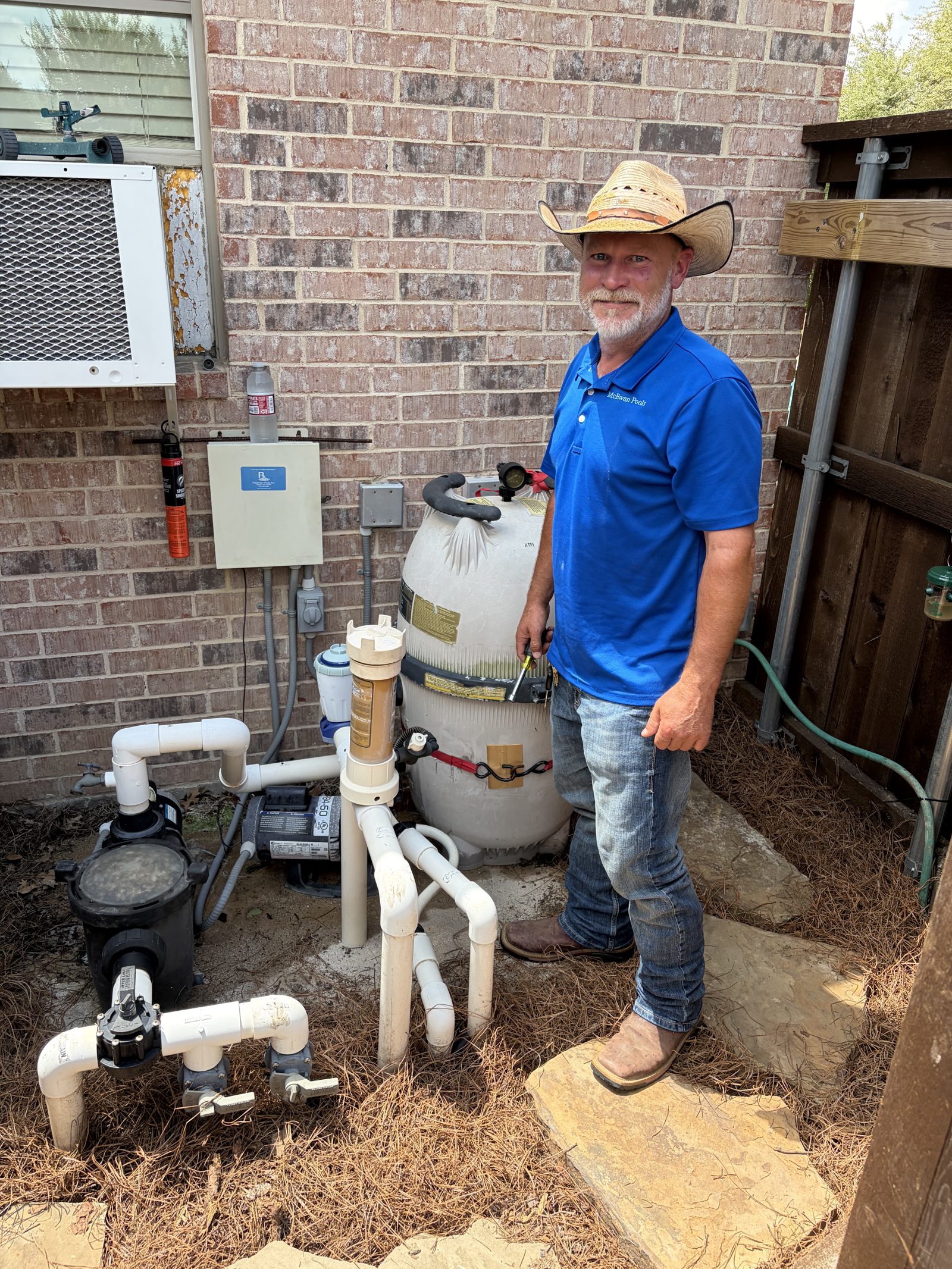 McEwan Pools owner at a pool equipment pad in Mansfield, TX