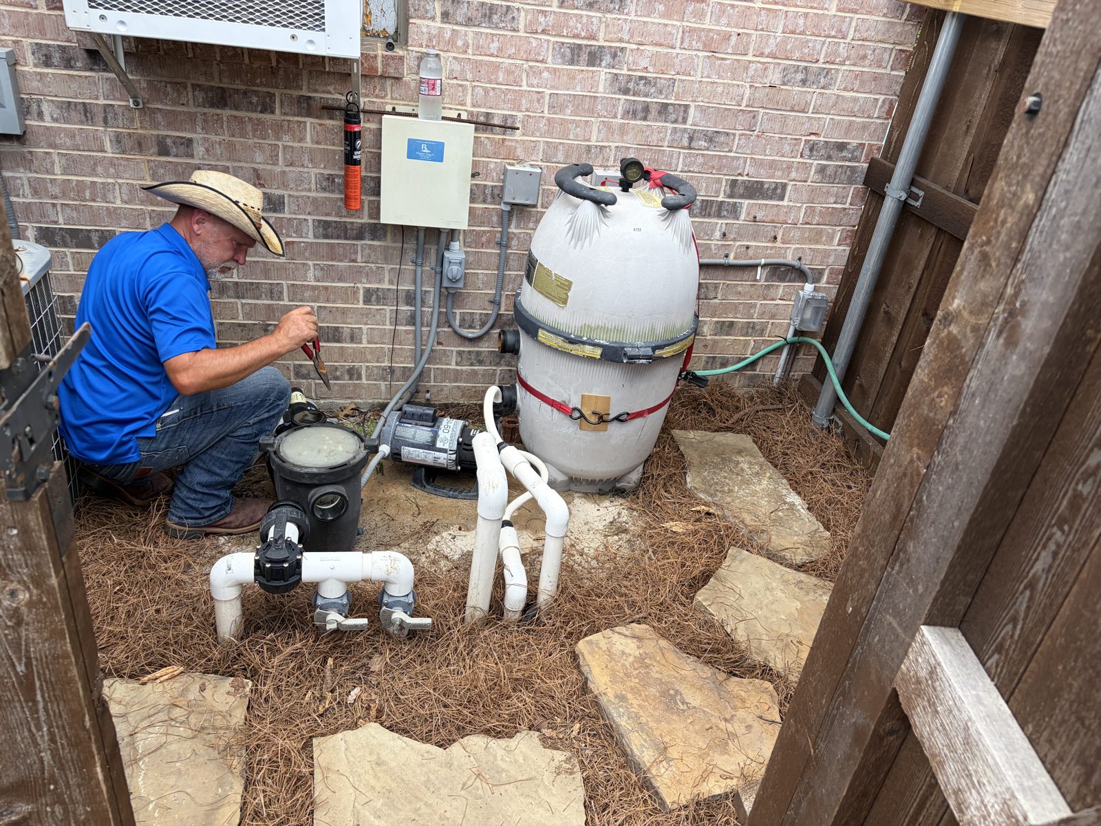 McEwan Pools working on a pool filter and pump system